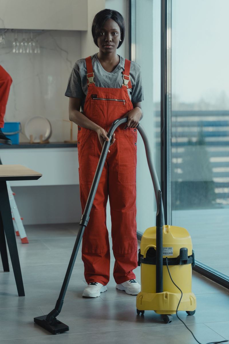 A cleaner at work in a bright home interior