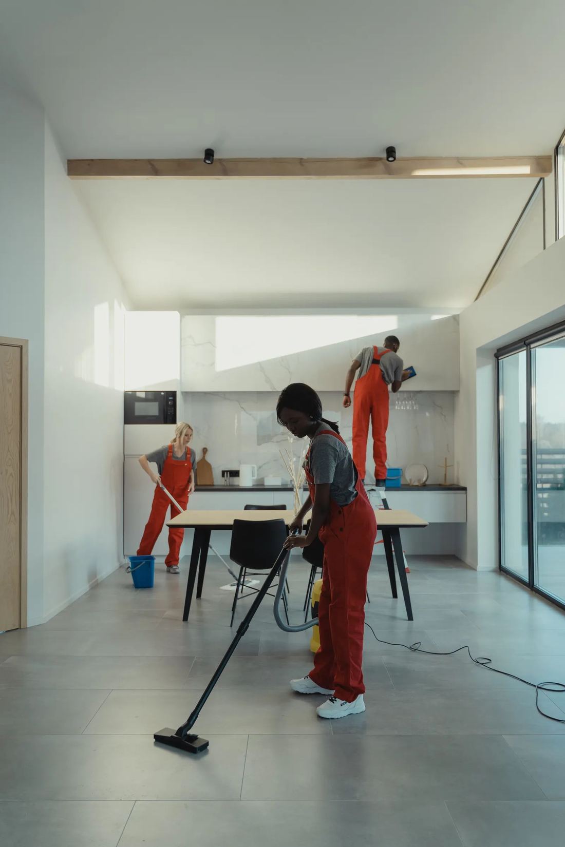 A bright, freshly cleaned living room with a vacuum ready for the next pass